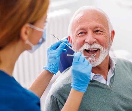 Man smiles at dental hygienist