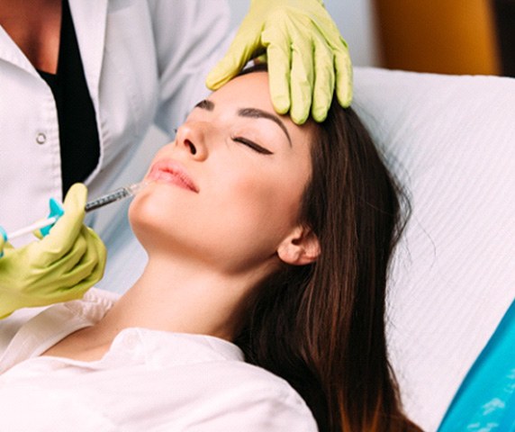 Woman relaxing while receiving dermal fillers in Vero Beach