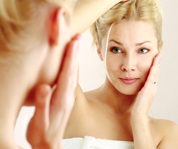 Woman looking at herself in mirror