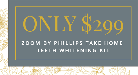 Ad for Zoom by Phillips teeth whitening kit. Gray background with gold floral accents. Text reads: 'ONLY $299, Zoom by Phillips Take Home Teeth Whitening Kit.'