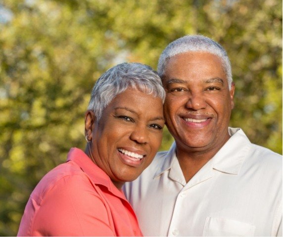 Senior man and woman smiling together outdoors