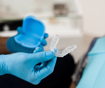 Orthodontist handing patient clear aligner