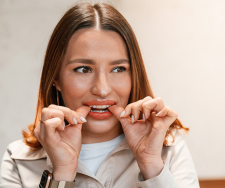 Patient putting on clear aligner in treatment room