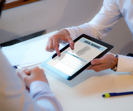 Patient reviewing dental insurance form on tablet