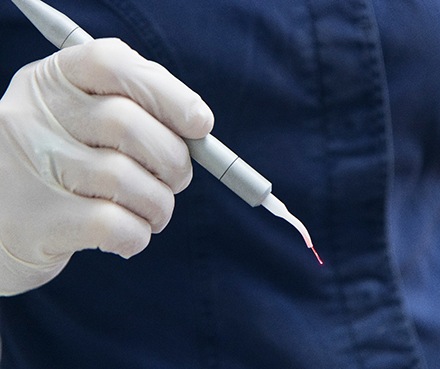 Dental team member holding laser device