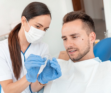 Dentist shows patient clear aligner?