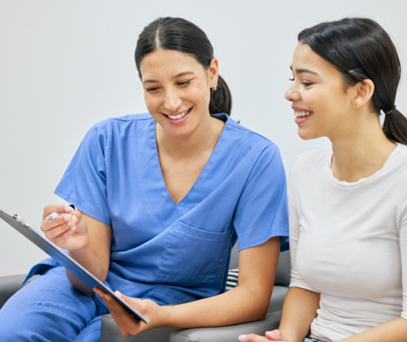 Dental staff member discussing payment with patient 