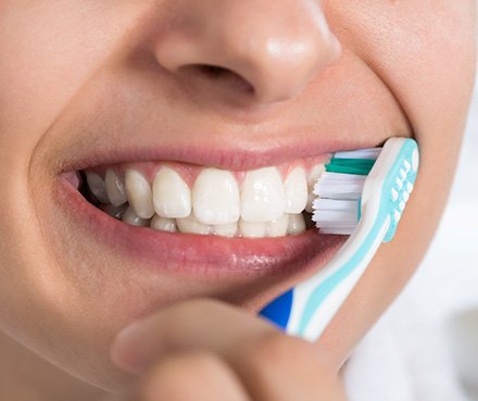 A woman brushing her teeth