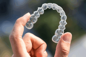 Close up of person holding an Invisalign tray